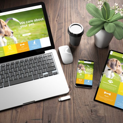three devices on wooden desk top view pet website 3d rendering of three devices with pet responsive website on screen on wooden desktop top view